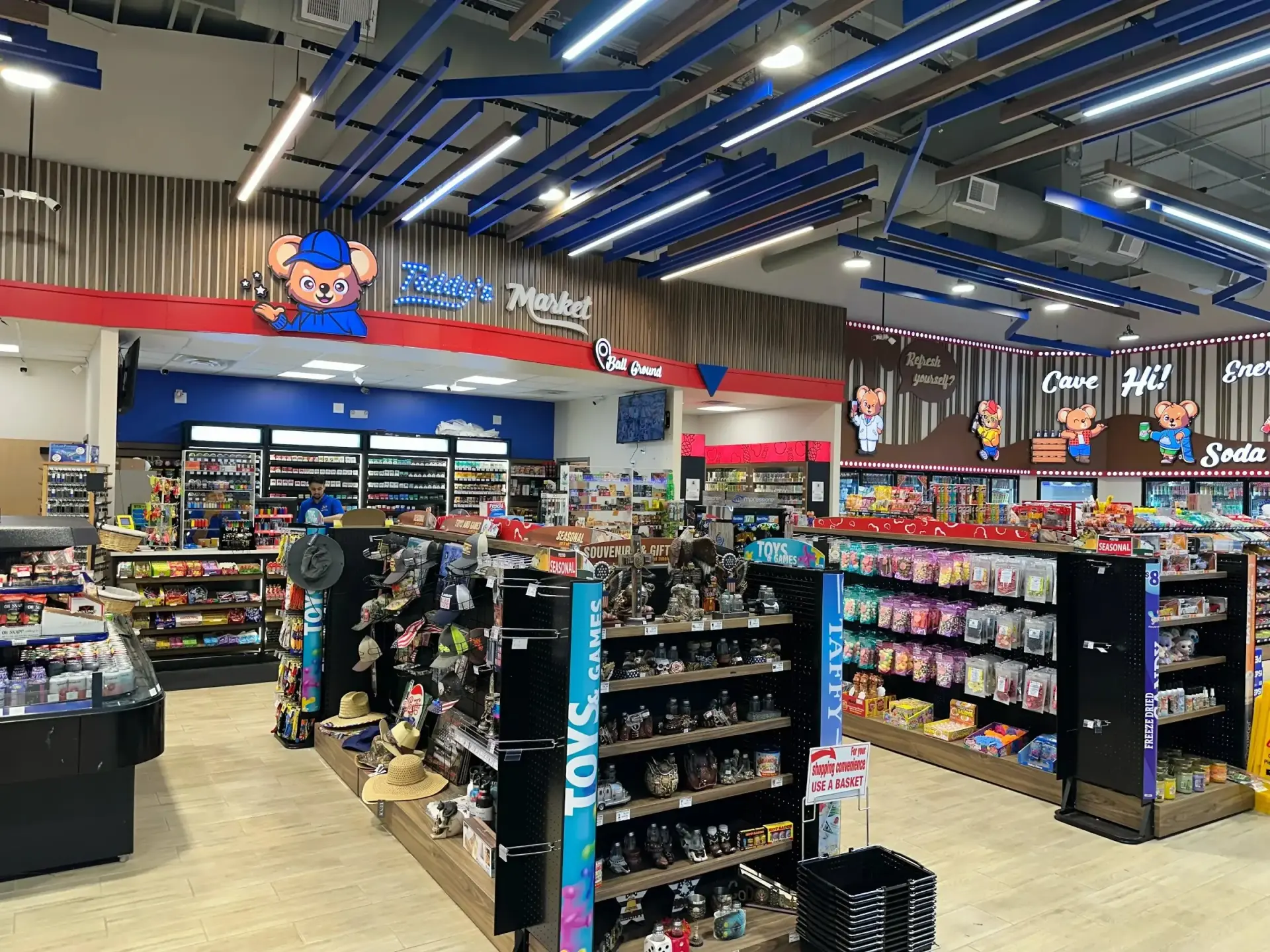 Teddy’s Market c-store interior with blue ceiling baffles and candy aisles