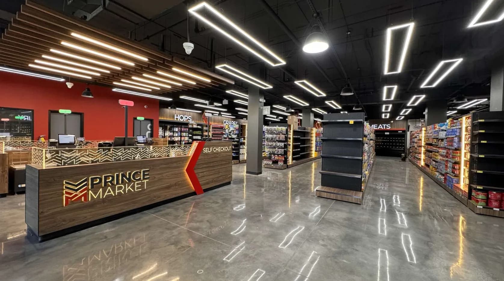 Checkout counter and grocery aisles under linear ceiling lights at Prince Market, Athens, Georgia